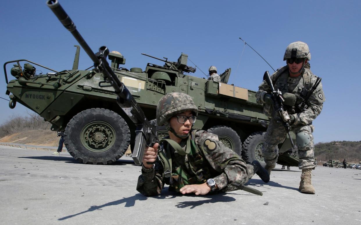 U.S. Army soldiers from the 25th Infantry Division's 2nd Stryker Brigade Combat Team and a South Korean Army soldier participate in a demonstration of the combined arms live-fire exercise during the annual joint military exercise Foal Eagle - AP