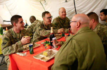 U.S. soldiers enjoy Thanksgiving lunch inside the U.S. army base in Qayyara, south of Mosul, Iraq November 24, 2016. REUTERS/Thaier Al-Sudani