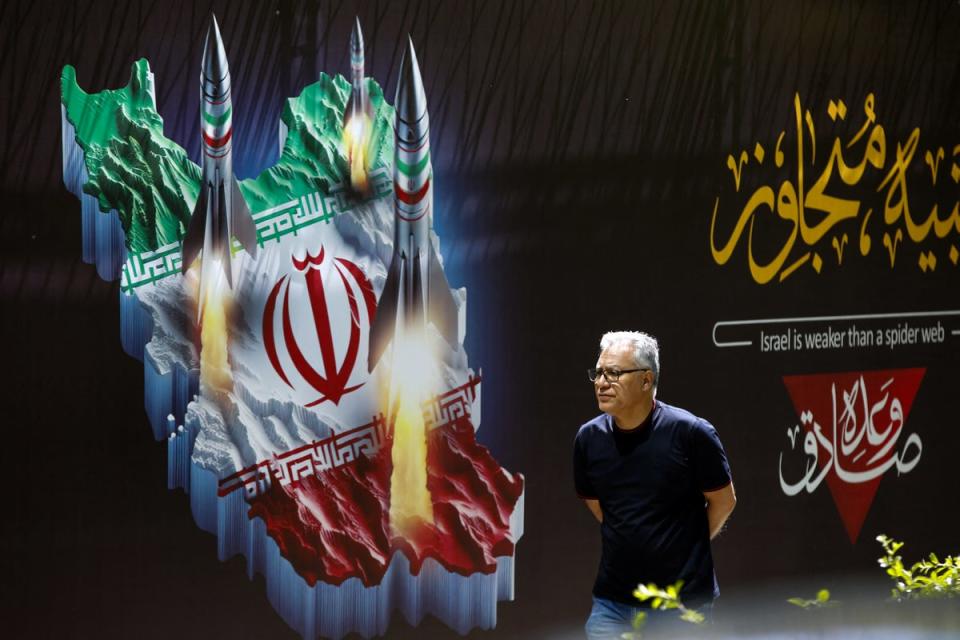 Tehran’s defences had shot down three drones launched from over 1,200 miles away in Israel. A man walks past a propaganda poster in Iran which reads ‘Israel is as weak as a spider web’ (AFP via Getty Images)