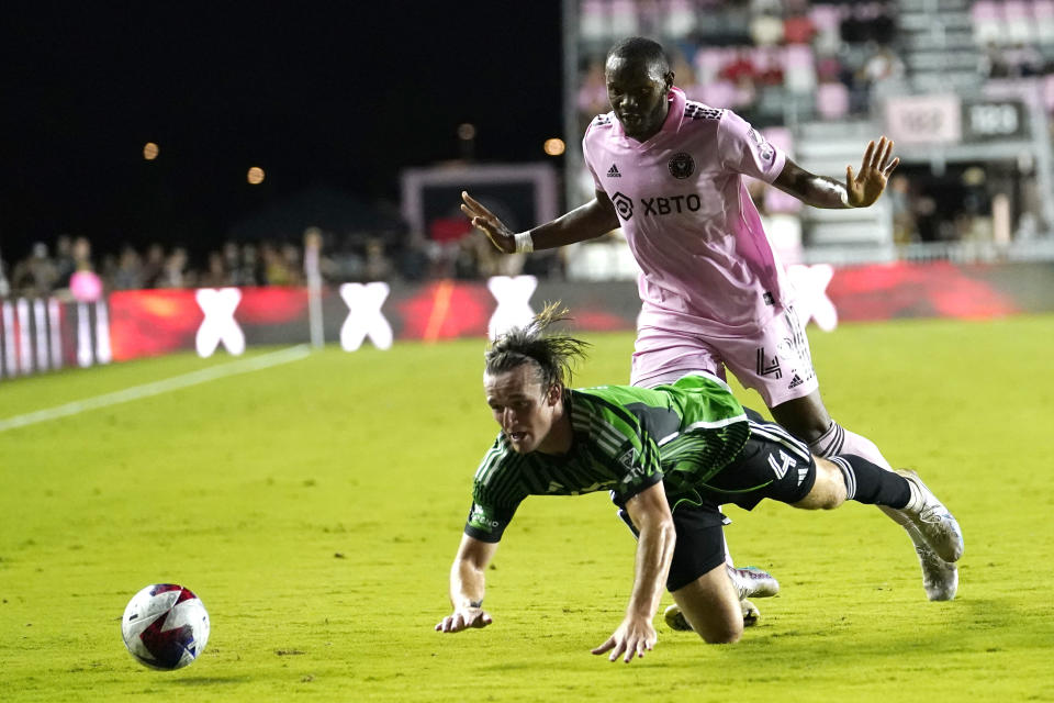 Austin FC defender Kipp Keller (4) falls to the field in front of Inter Miami forward Shanyder Borgelin during the second half of an MLS soccer match Saturday, July 1, 2023, in Fort Lauderdale, Fla. (AP Photo/Lynne Sladky)