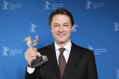 Rasmus Videbaek poses with Silver Bear for an Outstanding Artistic Contribution in the categories camera, editing, music score, costume or set design, after the awards ceremony at the 69th Berlinale International Film Festival in Berlin, Germany, February 16, 2019. Christoph Soeder/Pool via Reuters