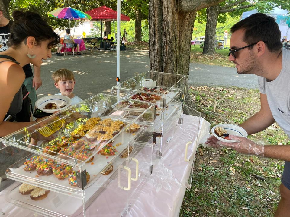 Family Dough’s Ryan Kraft serves a customer at the Tea & Treasures Second Saturday Marketplace on July 8, 2023