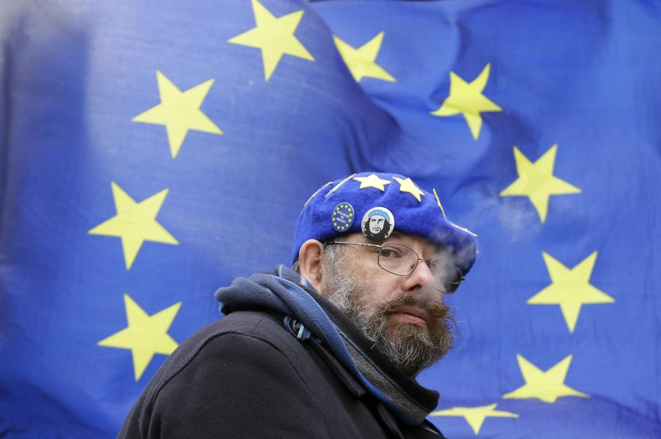 An anti-Brexit remain in the European Union supporter, takes part in a protest outside the House of Parliament in London, Wednesday, March 13, 2019. British lawmakers rejected May's Brexit deal in a 391-242 vote on Tuesday night. Parliament will vote Wednesday on whether to leave the EU without a deal. (AP Photo/Kirsty Wigglesworth)