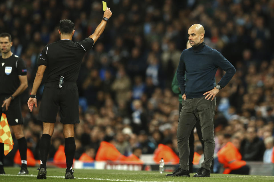 Manchester City's head coach Pep Guardiola is shown yellow card during the group C Champions League soccer match between Manchester City and Dinamo Zagreb at the City of Manchester Stadium in Manchester, England, Tuesday, Oct. 1, 2019. (AP Photo/Dave Thompson)