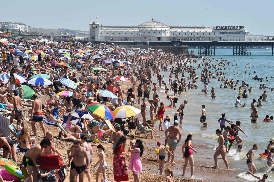 Hundreds of people descended on Brighton beach on Friday (AFP via Getty Images)