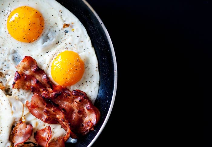 Two fried eggs and bacon strips on a plate, suggesting a classic breakfast meal