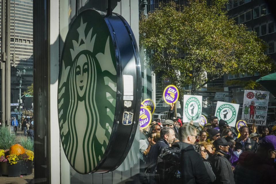 A coalition of unions and supporters join Starbucks workers at a rally outside a midtown Manhattan Starbucks coffee store calling for a "fair schedules and wages," Thursday, Nov. 16, 2023, in New York. (AP Photo/Bebeto Matthews)