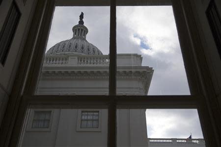 A general view of the U.S. Capitol dome as seen from a window outside the Senate chamber in Washington December 18, 2013. REUTERS/Jonathan Ernst