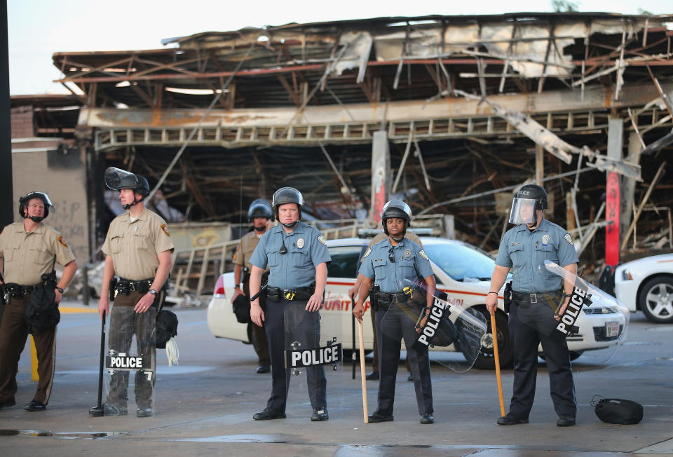 Police guard a Quick Trip gas station that was burned on Aug. 10&nbsp;when protests over the killing of 18-year-old Michael Brown turned to riots and looting.