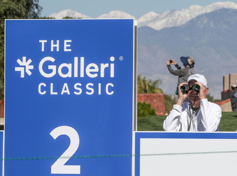 Volunteer Rich Shugg watches the golf action through a pair of binoculars at the Galleri Classic at Mission Hills Country Club in Rancho Mirage, March 26, 2023.