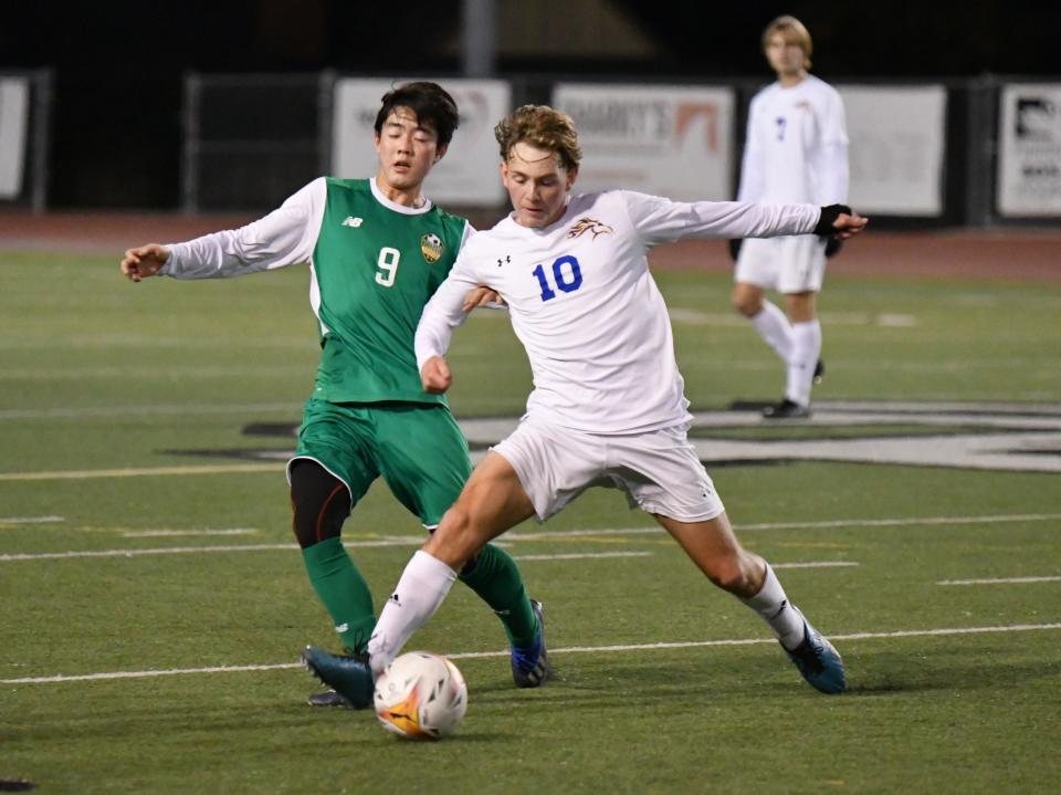 Agoura's Brandon Sosa (right) fights for possession with Thousand Oaks' No. 9 during their Marmonte League match on Wednesday night. The Chargers won 2-1 to improve to 9-0-5 overall and 5-0-2 in league.