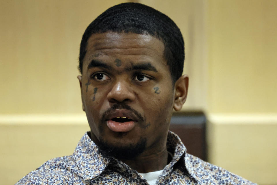 Suspected shooting accomplice Dedrick Williams speaks to someone in the courtroom gallery as attorneys meet with Judge Michael Usan for a sidebar discussion during closing arguments in the XXXTentacion murder trial at the Broward County Courthouse in Fort Lauderdale, Fla., Tuesday, March 7, 2023. Emerging rapper XXXTentacion, born Jahseh Onfroy, 20, was killed during a robbery outside of Riva Motorsports in Pompano Beach in 2018, allegedly by defendants Michael Boatwright, Trayvon Newsome, and Williams. (Amy Beth Bennett/South Florida Sun-Sentinel via AP, Pool)