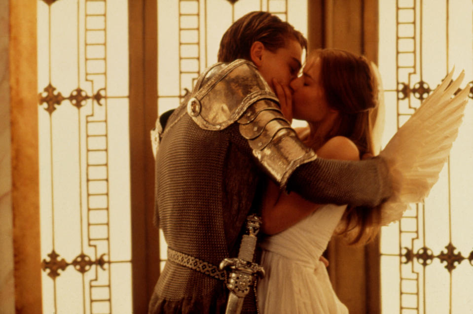 Leonardo Di Caprio dressed as a knight kisses Claire Danes dressed like an angel