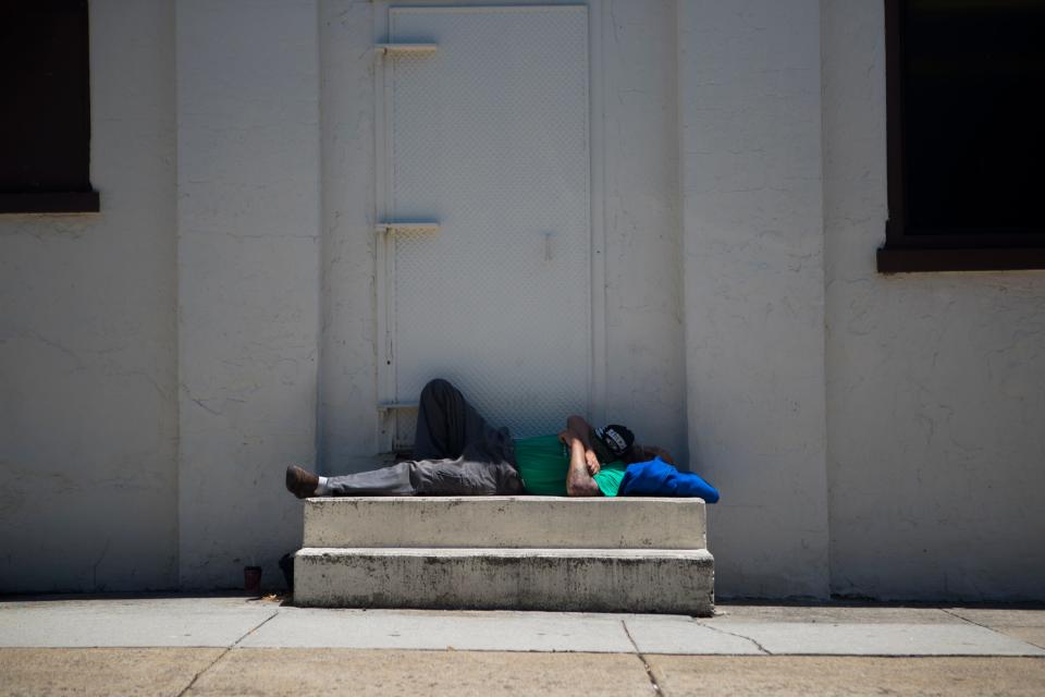 A man sleeps in the shade in downtown Wilmington, Tuesday, June 29, 2021. 