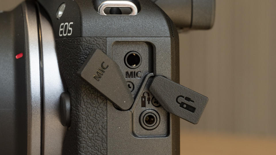 Canon EOS R100 camera on a table closeup of mic port