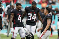 Atlanta Falcons wide receiver Tajae Sharpe (4) and cornerback Darren Hall (34) congratulate kicker Younghoe Koo (7) after he kicked the game-winning field goal during the second half of an NFL football game against the Miami Dolphins, Sunday, Oct. 24, 2021, in Miami Gardens, Fla. The Falcons defeated the Dolphins 30-28. (AP Photo/Wilfredo Lee)