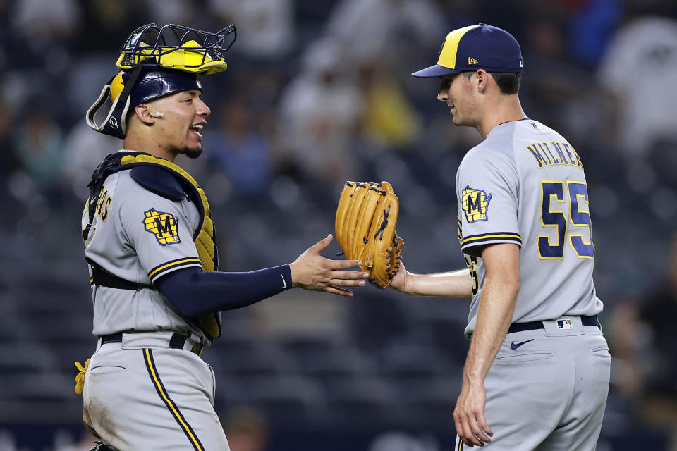 Milwaukee Brewers pitcher Hoby Milner (55) celebrates with William Contreras after they defeated the New York Yankees in a baseball game Saturday, Sept. 9, 2023, in New York. The Brewers won 9-2. (AP Photo/Adam Hunger)