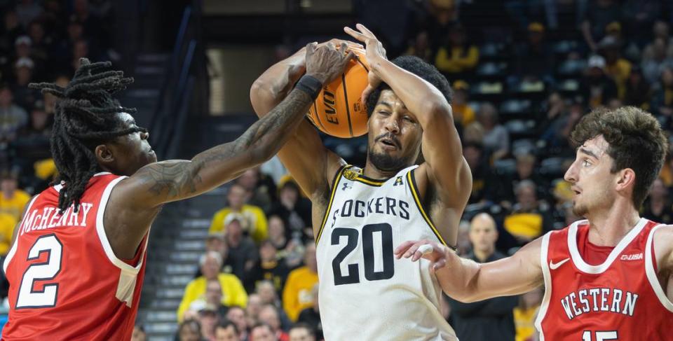 Wichita State’s Harold Beverly tries to get through the defense of Western Kentucky’s Don McHenry, left, and Jack Edelen during the second half of their game at Koch Arena on Thursday night.