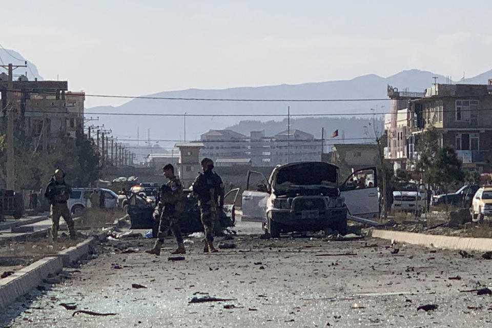 Afghan security personnel gather at the site of an explosion in Kabul, Afghanistan, Wednesday, Nov. 13, 2019. An explosion has rocked the Afghan capital of Kabul as early morning commuters were on the street heading to work. (AP Photo/Rahmat Gul)