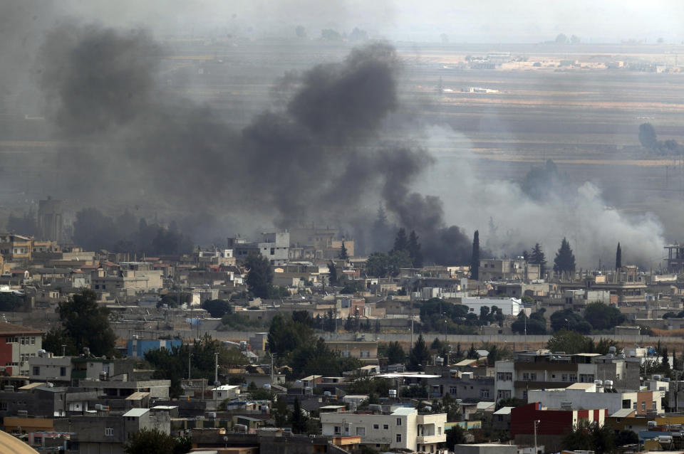 In this photo taken from the Turkish side of the border between Turkey and Syria, in Ceylanpinar, Sanliurfa province, southeastern Turkey, smoke billows from targets in Ras al-Ayn, Syria, during bombardment by Turkish forces, Wednesday, Oct. 16, 2019. Turkey's President Recep Tayyip Erdogan called Wednesday on Syrian Kurdish fighters to leave a designated border area in northeast Syria 'as of tonight' for Turkey to stop its military offensive, defying pressure on him to call a ceasefire and halt its incursion into Syria, now into its eighth day. (AP Photo/Lefteris Pitarakis)