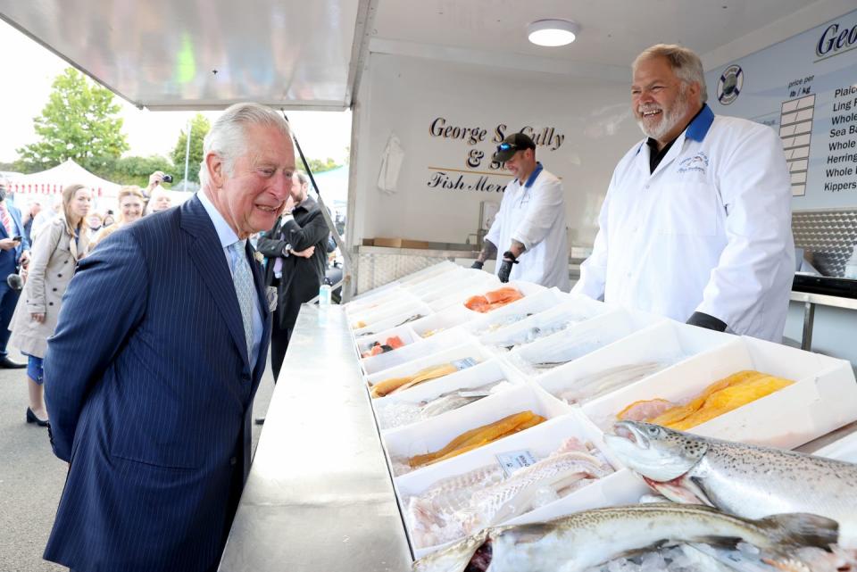 <p>Prince Charles makes eye contact with a fish at the Bangor open air market during a trip to Northern Ireland. </p>