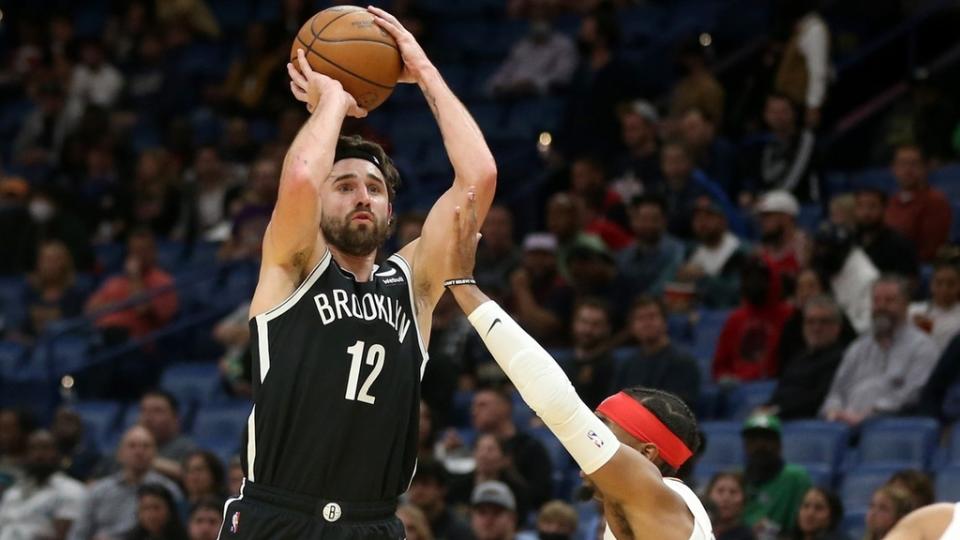 Nov 12, 2021; New Orleans, Louisiana, USA; Brooklyn Nets forward Joe Harris (12) attempts a jump shot while defended by New Orleans Pelicans guard Devonte' Graham (4) during the first quarter at the Smoothie King Center.
