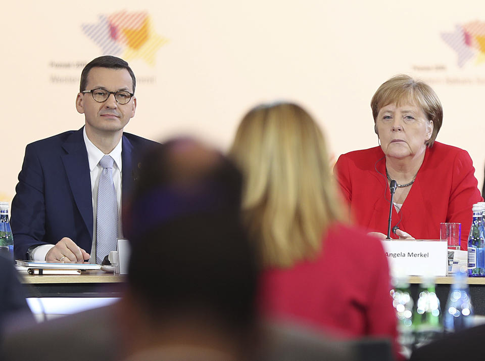 German Chancellor Angela Merkel,right, and Poland's Prime Minister Mateusz Morawiecki listening to a speech by Poland's President Andrzej Duda during a summit meeting that aims to reassure Western Balkan states that their aspirations to join the European Union have backing among EU leaders, in Poznan, Poland, Friday, July 5, 2019.(AP Photo/Czarek Sokolowski)