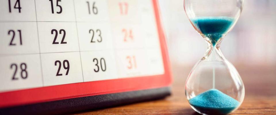 Hour glass and calendar concept for time slipping away for important appointment date, schedule and deadline