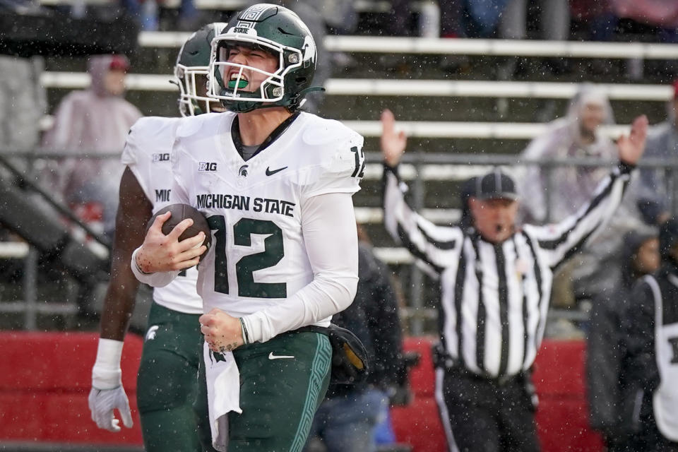 Michigan State quarterback Katin Houser (12) celebrates after scoring a touchdown during the first half of an NCAA college football game against Rutgers Saturday, Oct. 14, 2023, in Piscataway, NJ. (AP Photo/Bryan Woolston)