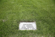 A grave marker for an unknown casualty from the USS Arizona is shown at the National Memorial Cemetery of the Pacific on Thursday, July 15, 2021 in Honolulu. Advances in DNA technology have allowed the U.S. military to exhume and identify the remains of hundreds of sailors and Marines buried as unknowns from the bombing of Pearl Harbor, decades after the 1941 attack that launched the U.S. into World War II. But the Defense POW/MIA Accounting Agency, which is responsible for locating and identifying missing servicemen and women, says it won't be able to do the same for those from the battleship that lost the most men that day: the USS Arizona. (AP Photo/Caleb Jones)