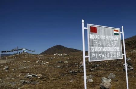 A signboard is seen from the Indian side of the Indo-China border at Bumla, in Arunachal Pradesh, November 11, 2009. REUTERS/Adnan Abidi/Files
