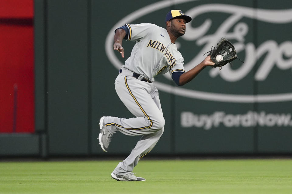 Milwaukee Brewers center fielder Lorenzo Cain (6) makes a running catch on a fly ball from Atlanta Braves' Marcell Ozuna during the fourth inning of a baseball game Friday, May 6, 2022, in Atlanta. (AP Photo/John Bazemore)