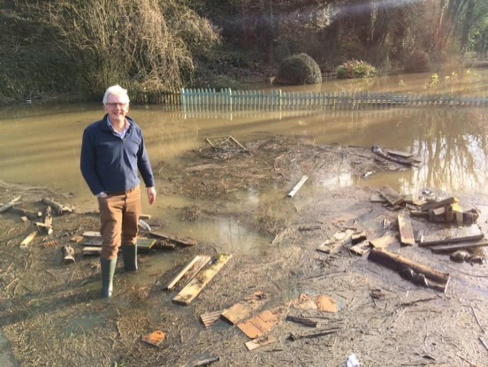 Alex Nicoll, manager of the Water Rat, wades into the pub’s garden area (Colin Drury/The Independent)