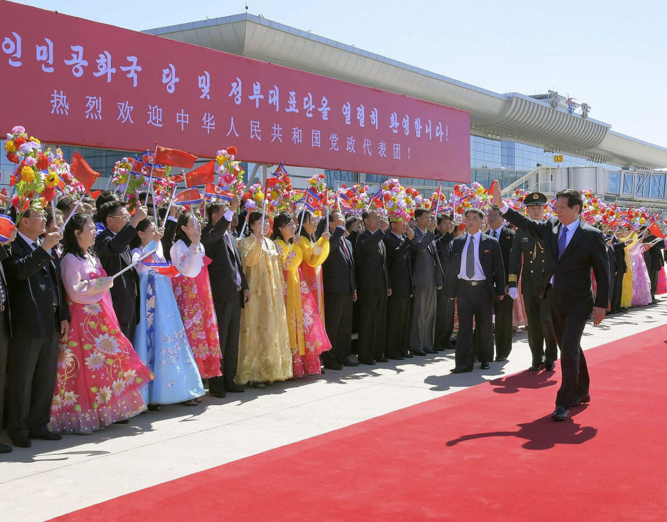 Senior Chinese official Li Zhanshu, right, is welcomed upon his arrival at Pyongyang International Airport in Pyongyang, North Korea, Saturday, Sept. 8, 2018. Li, the Chinese ruling party's third highest official, will attend a big military parade on the 70th anniversary of North Korea's founding on Sunday, Sept. 9. (Kyodo News via AP)/Kyodo News via AP)