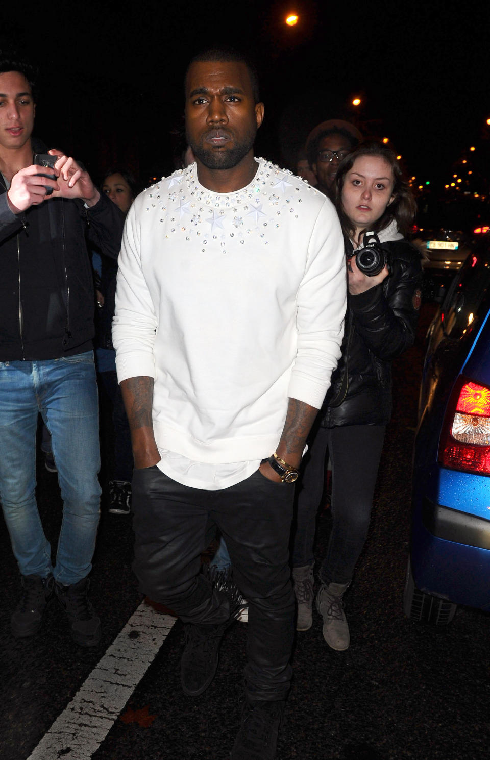 Kanye West arrives for the Givenchy's fashion house presentation for Women's Fall-Winter, ready-to-wear 2013 fashion collection, during Paris Fashion week, Sunday, March 4, 2012. (AP Photo/Zacharie Scheurer)