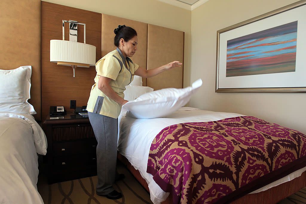 A housekeeper, at the Ritz-Carlton, Key Biscayne hotel prepares a room for a new occupant