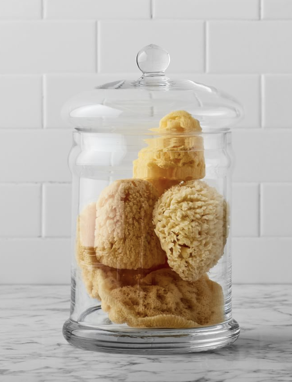 Glass Canister With Lid holding loofah sponges