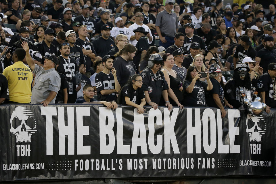 FILE - In this Aug. 31, 2017, file photo, Oakland Raiders fans watch from the Black Hole section of Oakland Alameda County Coliseum during the first half of an NFL preseason football game between the Raiders and the Seattle Seahawks in Oakland, Calif. The slow, agonizing demise of the Oakland Raiders will continue for at least one more season. There will be one more "final" home game at the Oakland Coliseum, Dec. 15 against the Jacksonville Jaguars. There have been possible "final" home games for a few years now because the Raiders have essentially had one foot out the door since 2015, when they joined with the AFC West rival Chargers in a failed attempt to build a stadium in the Los Angeles suburb of Carson. (AP Photo/Eric Risberg, File)