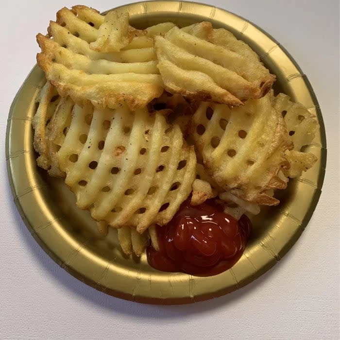 Same reviewer's photo of a plate of waffle fries with ketchup made using the Ninja air fryer
