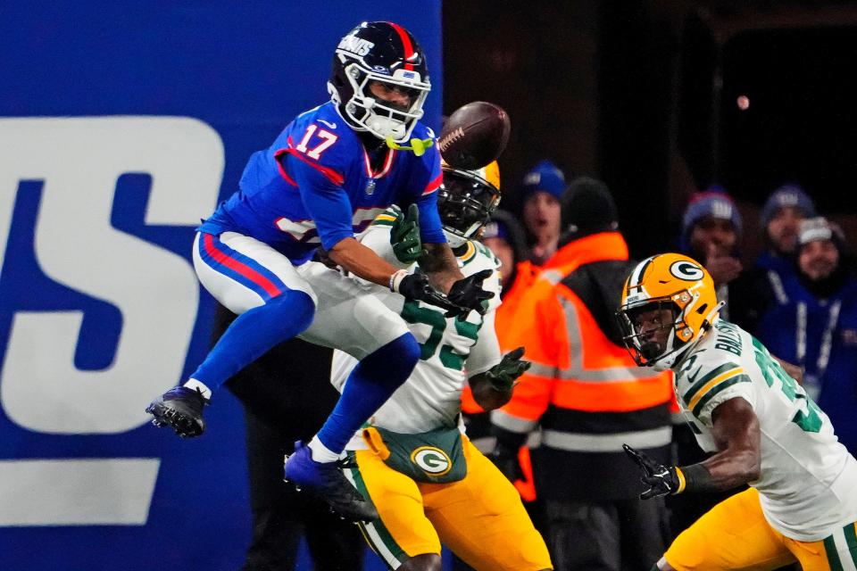 Dec 11, 2023; East Rutherford, New Jersey, USA; New York Giants wide receiver Wan'Dale Robinson (17) makes a catch against Green Bay Packers linebacker De'Vondre Campbell (59) and cornerback Corey Ballentine (35) during the third quarter at MetLife Stadium. Mandatory Credit: Robert Deutsch-USA TODAY Sports