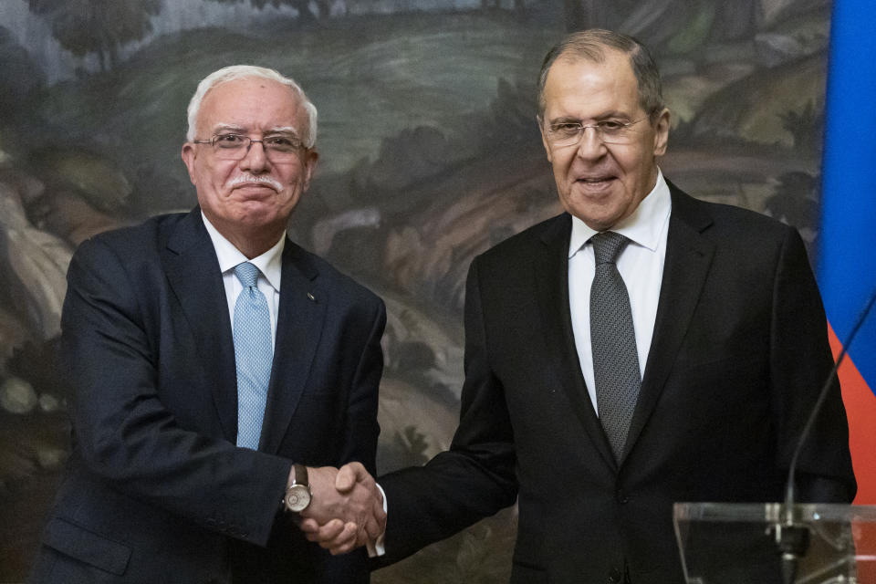 Russian Foreign Minister Sergey Lavrov, right, and Palestinian Foreign Minister Riyad Al-Maliki shake hands as they leave a joint news conference following their talks in Moscow, Russia, Wednesday, May 5, 2021. (AP Photo/Alexander Zemlianichenko, Pool)