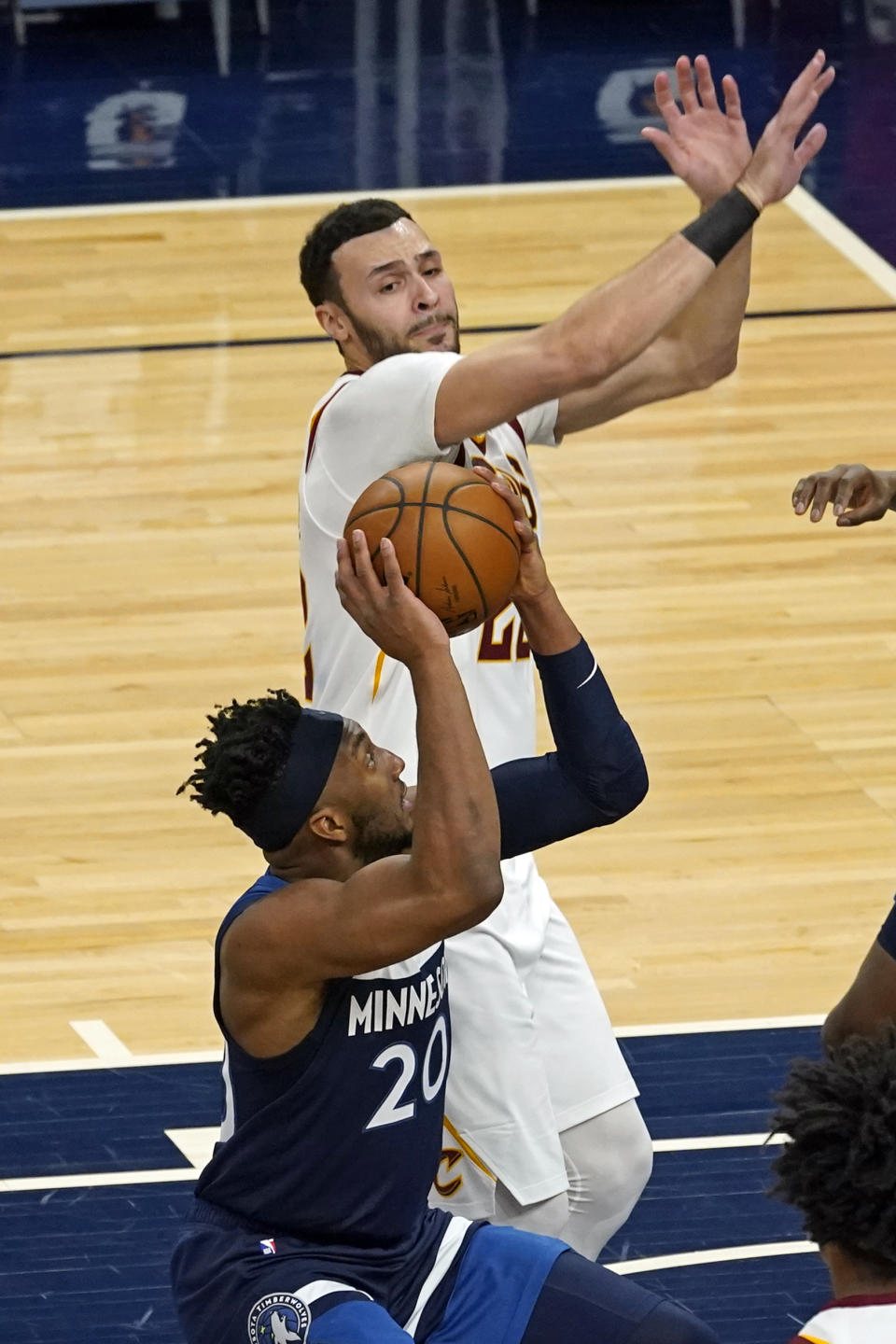 Minnesota Timberwolves' Josh Okogie (20) looks to shoot as Cleveland Cavaliers' Larry Nance Jr. (22) defends in the first half of an NBA basketball game Sunday, Jan. 31, 2021, in Minneapolis. (AP Photo/Jim Mone)