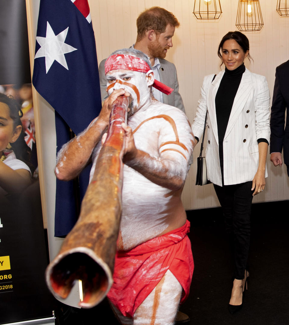 Britain's Prince Harry and his wife Meghan, the Duchess Sussex attend a lunchtime reception hosted by Prime Minister Scott Morrison with Invictus Games competitors, their family and friends in the city's central parkland in Sydney on Sunday, Oct. 21, 2018. (Paul Edwards/Pool Photo via AP)