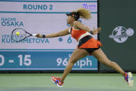 Naomi Osaka, of Japan, returns a shot to Veronika Kudermetova, of Russia, at the BNP Paribas Open tennis tournament Saturday, March 12, 2022, in Indian Wells, Calif. (AP Photo/Mark J. Terrill)