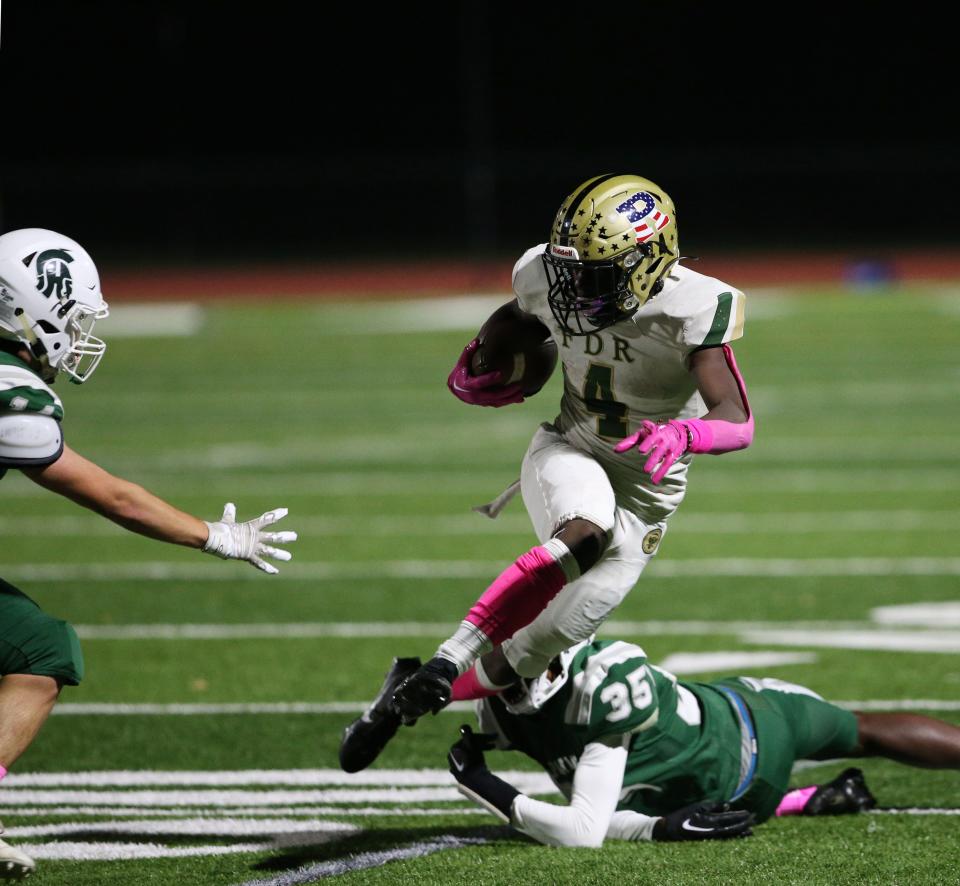 Roosevelt's Presley Kafeero eludes a Spackenkill defender during an Oct. 13, 2023 football game.