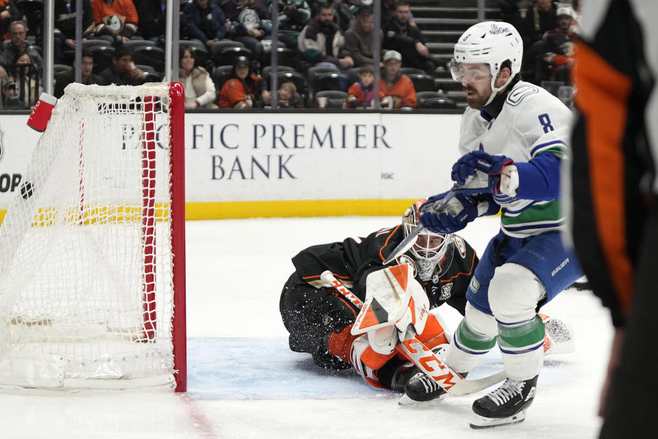 Vancouver Canucks right wing Conor Garland, right, scores on Anaheim Ducks goaltender Lukas Dostal during the second period of an NHL hockey game Sunday, March 3, 2024, in Anaheim, Calif. (AP Photo/Mark J. Terrill)