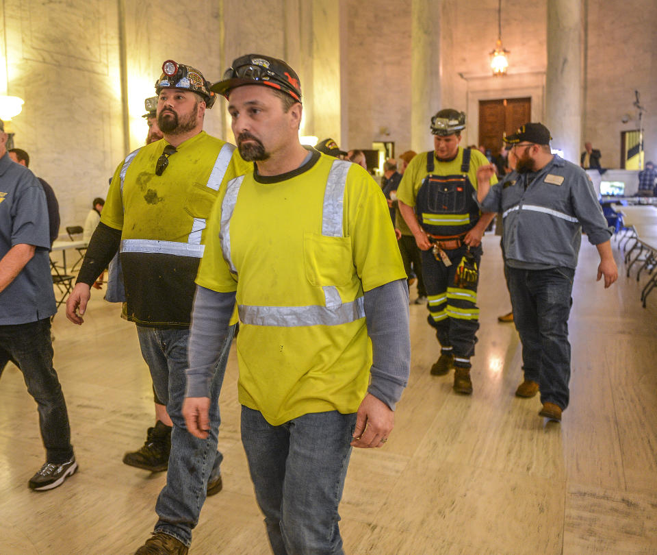 Coal miners leave the chamber of the West Virginia House of Delegates after speaking against a bill to strip regulatory authority from the state office of miners' health, safety and training at the state Capitol on Monday, Feb. 28, 2022 in Charleston W.Va. (Kenny Kemp/Charleston Gazette-Mail via AP)