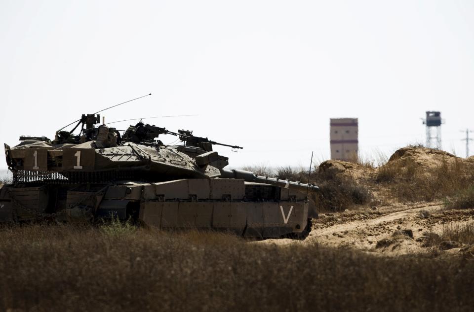 An Israeli army tank takes position along Israel's border with Egypt