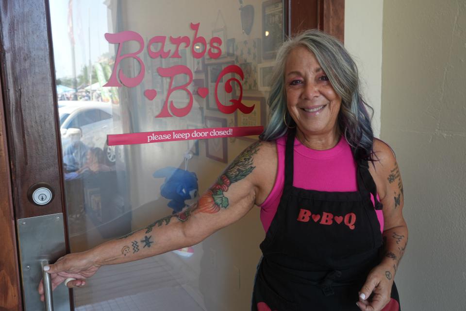 Joanne Irizarry, seen here on July 29, is an investor and also now opens the door for customers at Barbs-B-Q.