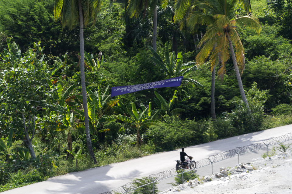 A person rides near the fence line as seen from a VM-22 Osprey on approach for landing at Jeremie Airport, Saturday, Aug. 28, 2021, in Jeremie, Haiti. The VMM-266, "Fighting Griffins," from Marine Corps Air Station New River, from Jacksonville, N.C., are flying in support of Joint Task Force Haiti after a 7.2 magnitude earthquake on Aug. 22, caused heavy damage to the country. (AP Photo/Alex Brandon)